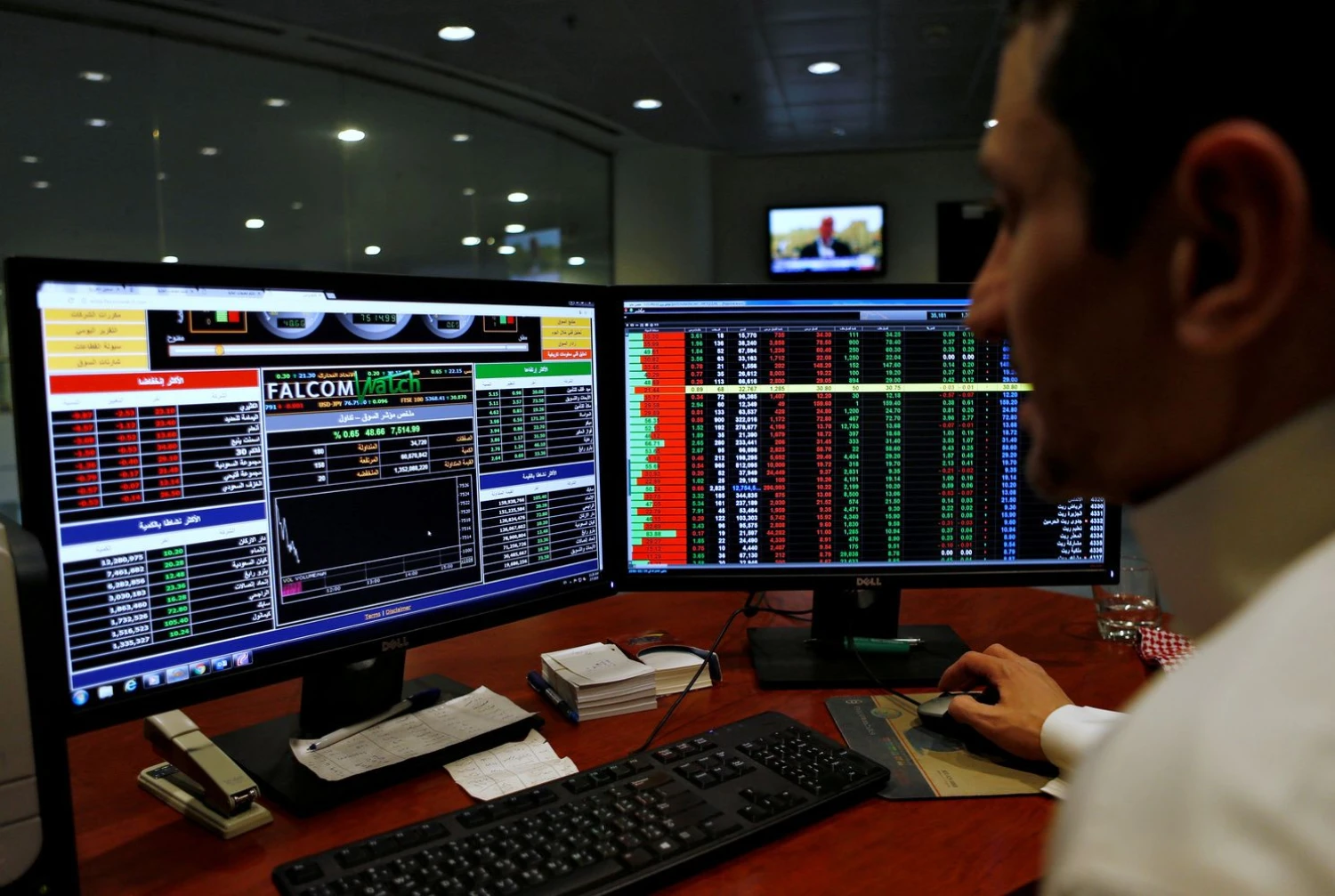 FILE PHOTO: A Saudi trader observes the stock market on monitors at Falcom stock exchange agency in Riyadh, Saudi Arabia February 7, 2018. REUTERS/Faisal Al Nasser/File Photo