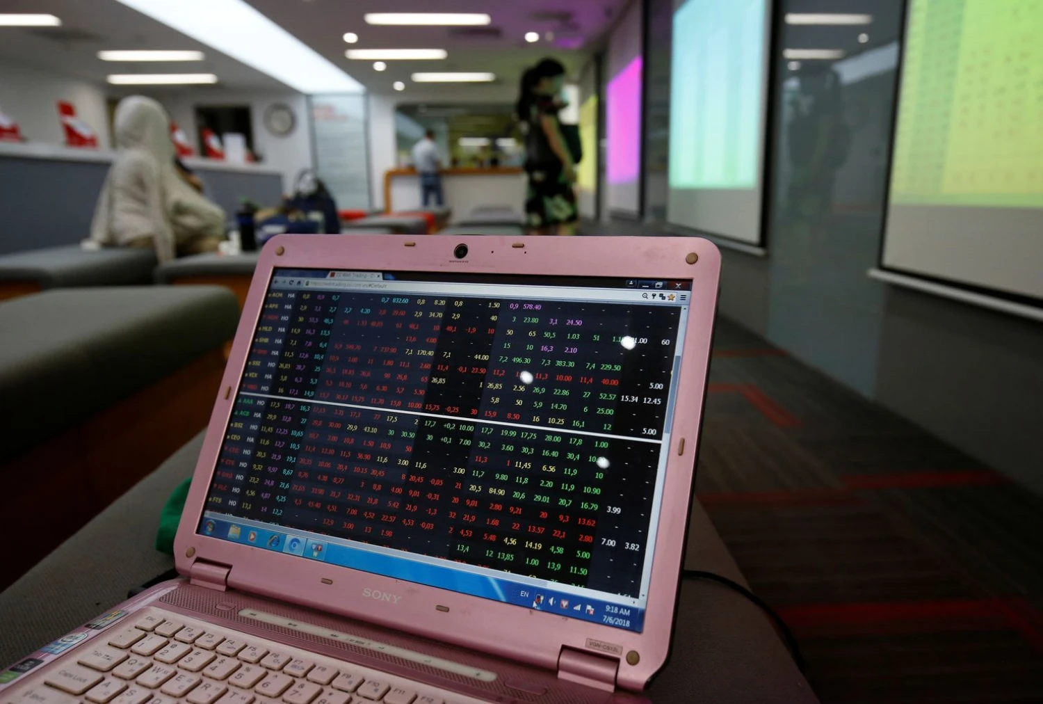 A screen displays stock board information at a securities company in Hanoi, Vietnam July 6, 2018. Picture taken July 6, 2018.  REUTERS/Kham