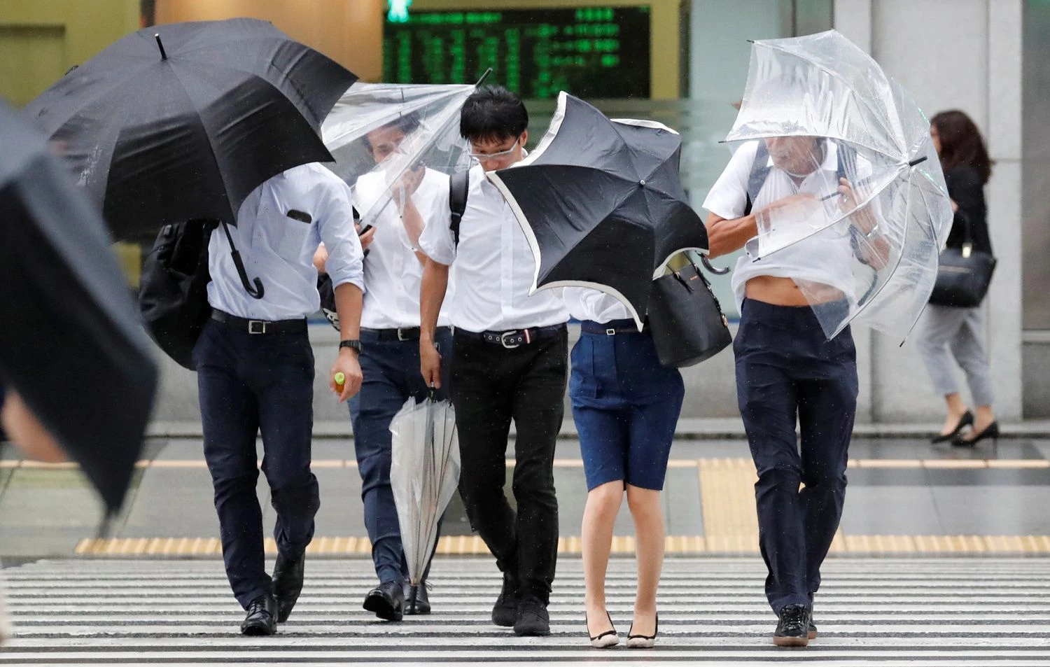 Passersby using umbrellas struggle against strong wind and rain caused by Typhoon Jebi, in Tokyo, Japan,  September 4, 2018.   REUTERS/Toru Hanai