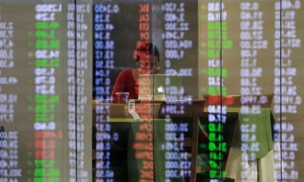 Philippine Stocks Exchange (PSE) share prices are reflected on a glass panel as broker takes a break in Manila's Makati financial district February 6, 2014. Major Southeast Asian stock markets rose on Thursday, with Singapore rebounding from a 14-month closing low hit in the previous session amid gains in Asian stock markets, while bargain hunting helped Thai shares plagued with political risks.  REUTERS/Romeo Ranoco  (PHILIPPINES - Tags: BUSINESS TPX IMAGES OF THE DAY)
