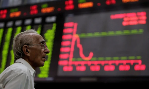FILE PHOTO: A man monitors an electronic board displaying stock prices at the Karachi Stock Exchange August 5, 2011. Pakistani stocks provisionally ended 3.78 percent lower on Friday as foreign investors offloaded their holdings amid a global sell-off, while local investors remained cautious, dealers said. REUTERS/Akhtar Soomro/File Photo