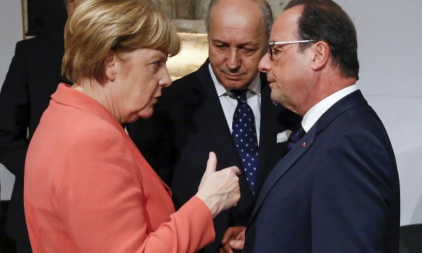 German Chancellor Angela Merkel (L) talks with French Foreign Minister Laurent Fabius (C) and French President Francois Hollande (R) at the start of the Valletta Summit on Migration in Valletta, Malta, November 11, 2015. REUTERS/Yves Herman