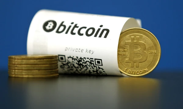 A Bitcoin (virtual currency) paper wallet with QR codes and a coin are seen in an illustration picture taken at La Maison du Bitcoin in Paris, France, May 27, 2015. British authorities have come out in support of digital currencies in the name of promoting financial innovation, while proposing that regulations should be drawn up to prevent their use in crime. But it is technophiles who are leading the drive to make London a real-world hub for trade in web-based "cryptocurrencies", of which bitcoin is the original and still most popular.   Picture taken May 27, 2015.  REUTERS/Benoit Tessier