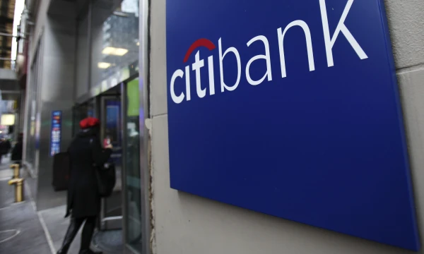 A woman walks into a Citibank branch in New York in this January 17, 2012 file photo. Citigroup said second quarter profits dropped as it lost money on the sale of a sake in a Turkish bank and suffered from the drag of its troubled assets left over from the 2007-2008 credit crisis. REUTERS/Shannon Stapleton/Files (UNITED STATES - Tags: BUSINESS)