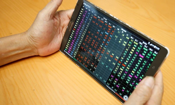 An investor looks at a screen showing stock board at a securities company in Hanoi, Vietnam July 6, 2018. Picture taken July 6, 2018. REUTERS/Kham