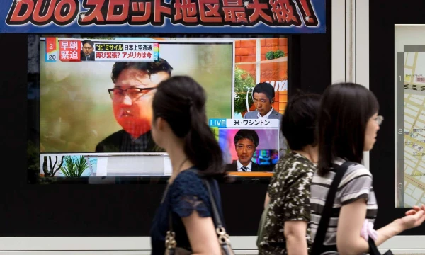 Pedestrian walk past a TV screen on a street displaying North Korean leader Kim Jong-un after North Korea's missile launch, in Tokyo, Japan, 29 August 2017. SIPA 
