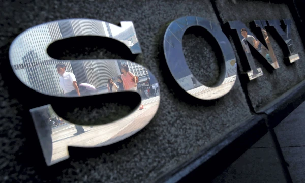 Pedestrians are reflected in a logo of Sony Corp outside its showroom in Tokyo, Japan, June 23, 2015. REUTERS/Yuya Shino