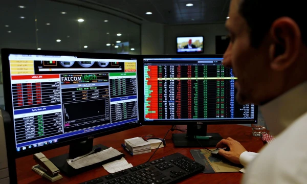 FILE PHOTO: A Saudi trader observes the stock market on monitors at Falcom stock exchange agency in Riyadh, Saudi Arabia February 7, 2018. REUTERS/Faisal Al Nasser/File Photo